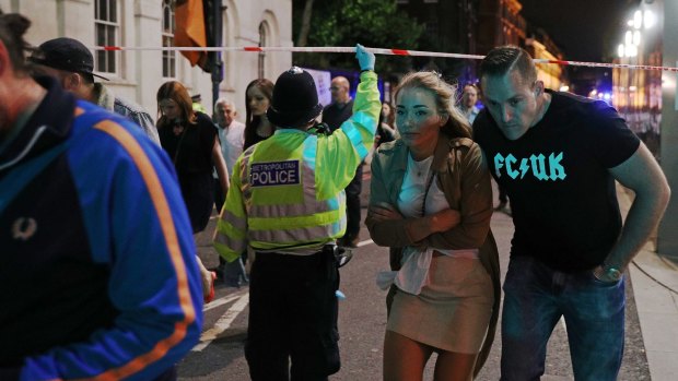 Members of the public are led away from the scene near London Bridge after the attack.