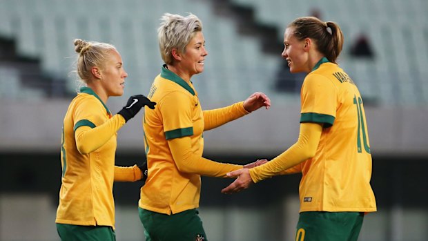 Emily van Egmond, right, celebrates scoring the Matildas' seventh goal.