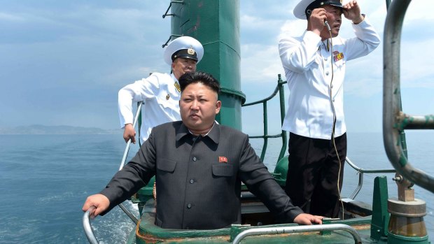 Lost from view: Kim Jong-un inspects a submarine in June.