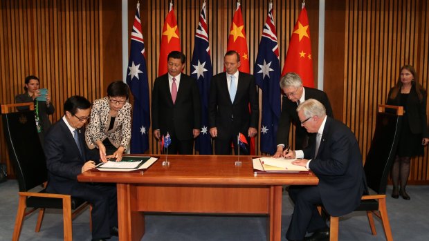 Chinese President Xi Jinping and then prime minister Tony Abbott witness the signing of the declaration of intent on the Australia/China Free Trade Agreement at Parliament House in Canberra.