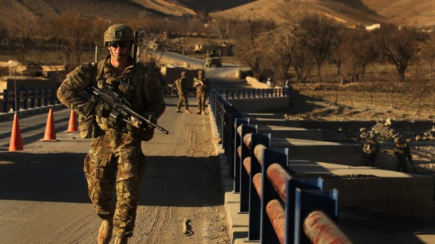 Australian soldiers patrol and search the Puza Bridge for bombs in Oruzgan Province in January, 2013.