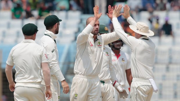 Australia's Nathan Lyon celebrates with his teammates after the dismissal of Bangladesh's Mominul Haque.