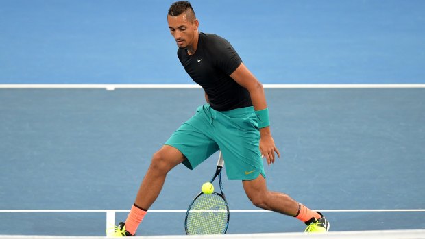 Nick Kyrgios plays some trick shots during practice on Tuesday.