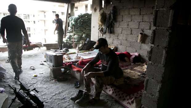 Soldiers from Iraq's elite counterterrorism forces rest in an unfinished apartment building serving as a battle position just outside Fallujah last week. 