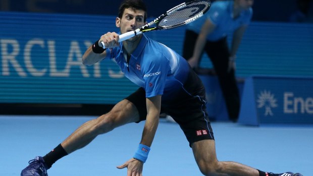 At a stretch: Serbia's Novak Djokovic plays a return to Spain's Rafael Nadal during their ATP World Tour Finals semi at the O2 Arena in London.