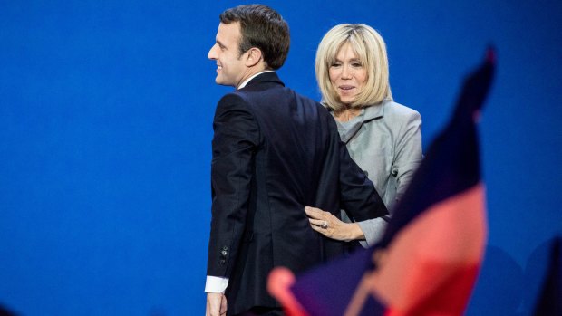 Emmanuel Macron arrives with his wife Brigitte to deliver a speech after the first round of the French presidential election.