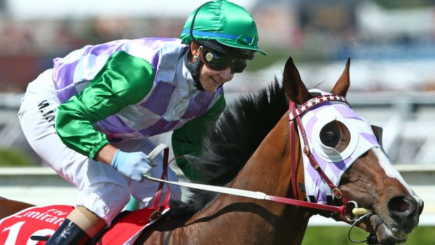 Michelle Payne, riding Prince Of Penzance, smiles after winning the Melbourne Cup.