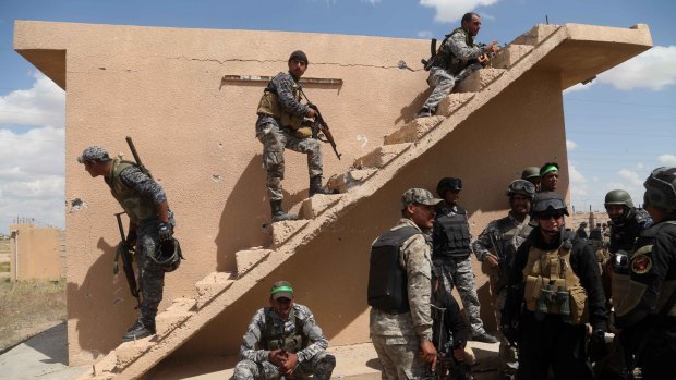 Iraqi security forces and allied Shiite militiamen prepare to attack Islamic State extremists in Tikrit.