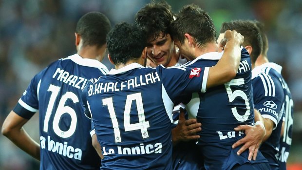 Guilherme Finkler of the Victory is congratulated by his teammates after scoring against Wellington Phoenix on Monday.