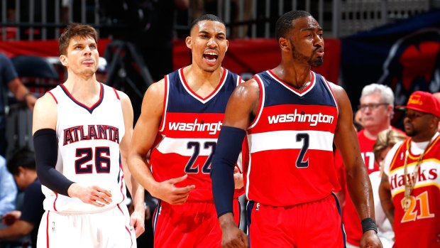 Upset win: John Wall and Otto Porter react after a basket in the final seconds against the Atlanta Hawks.