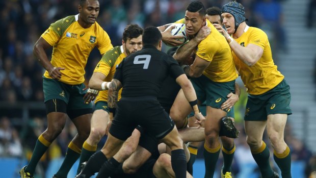 Spectacle: Israel Folau is tackled by Aaron Smith during the Rugby World Cup final between New Zealand and Australia at Twickenham Stadium.