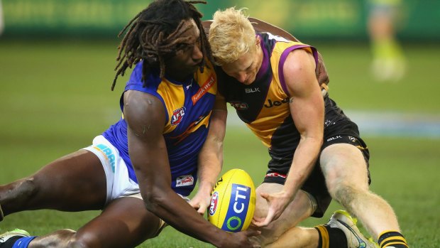 Eagles ruckman Nic Naitanui and Steven Morris of the Tigers compete for the ball on Friday.