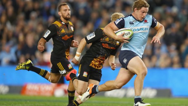 Blue patch: Waratahs skipper Michael Hooper on the way to scoring one of his two tries against the Chiefs.