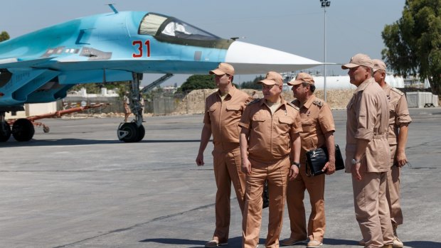 Russian Defence Minister Sergei Shoigu, second from left, visits the Hmaymim air base in Syria on Saturday.