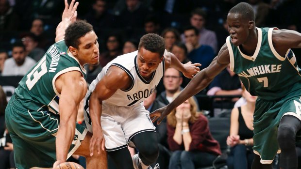 Thon Maker (right) applies the pressure as Bucks guard Malcolm Brogdon strips the ball from Nets guard Yogi Ferrell.