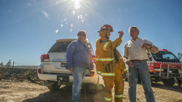 Mulloon Creek Natural Farms owners Tony Coote, Gary Nairn and Michael Fitzgerald assess the damage to their property.