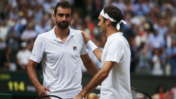 Roger Federer and Marin Cilic shake hands after Federer won in straight sets.