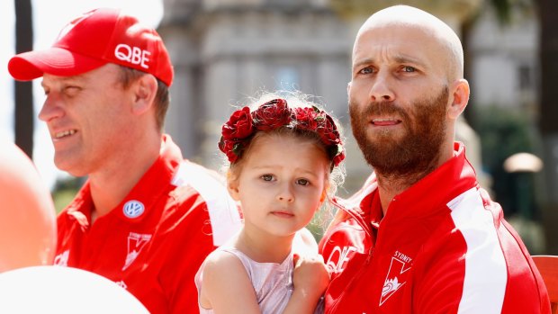 Jarrad McVeigh and his daughter take part in the parade.