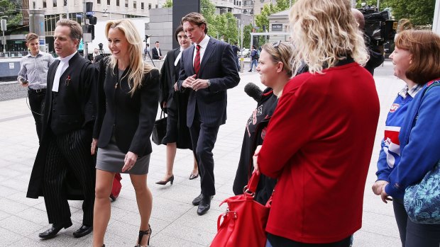 Essendon supporters greet Tania and James Hird as they arrive at the Federal Court in Melbourne on Tuesday.