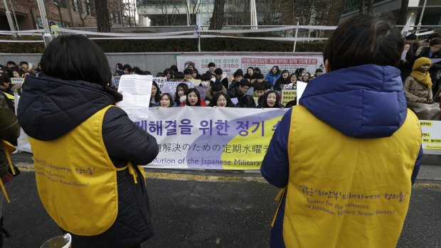 South Korean middle school students stage a rally demanding full compensation and apology for wartime sex slaves from the Japanese government in front of the Japanese Embassy in Seoul, South Korea, on Wednesday.