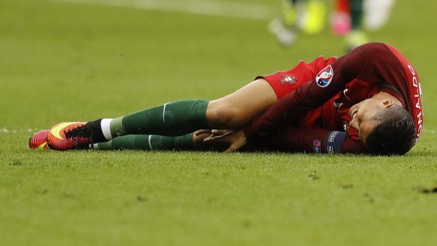 Cristiano Ronaldo lies on the pitch in pain during the Euro 2016 final.
