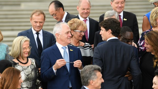 Prime Minister Malcolm Turnbull (centre) and his wife Lucy (left) speak to Canadian Prime Minister Justin Trudeau as they arrive for a ''family'' photo at the G20 summit in Hamburg.