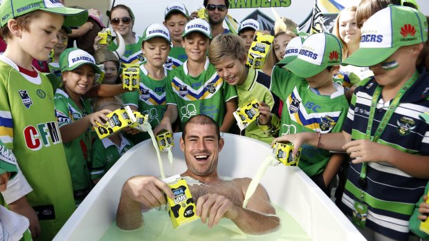 Former Raiders captain Terry Campese takes a bath in Raiders Lime when the milk was reintroduced in 2013. Canberra Milk has stopped production.