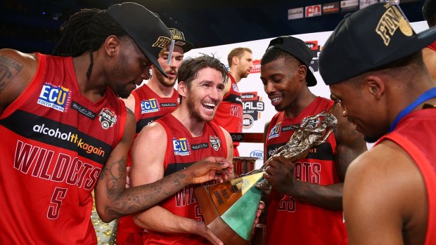 The Perth Wildcats celebrate with the NBL trophy.