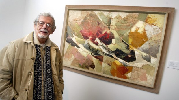 Gil Docking in front of the painting Flight of a Tree, painted by his wife Shay in memory of her brother Ted, who was killed in World War II. 