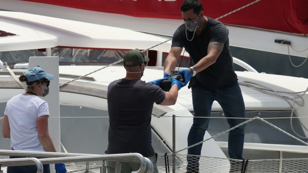 Police moving the cocaine from the vessel on Thursday. 