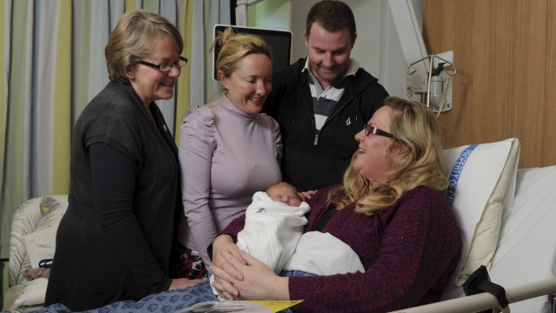 The 1000th baby born in the CaTCH program, Lucy Grace Cassells, with her mother Amy Hicks and father Nick Cassells, at the Centenary Women and Children's hospital, Woden. At left is Christine Fowler, the clinical midwife manager, and second from left is midwife Felicity Finn. 