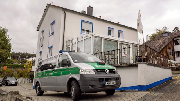 A police van in front of the home where an anti-government extremist opened fire on police on Wednesday.