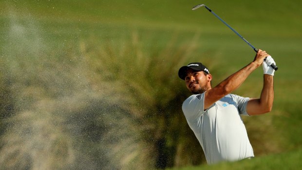 Jason Day of Australia plays a shot from a bunker on the 11th hole in the first round of the Players Championship.