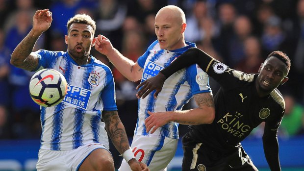 Huddersfield Town's Danny Williams, left, and Aaron Mooy (centre) in action against Leicester City's Wilfred Ndidi.