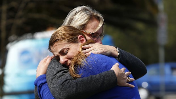 Connie Olczac is comforted after a press conference in which she and police asked for information.about her missing daughter Cassie Olczac.