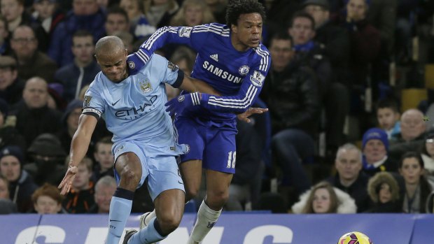 Battling: Chelsea's Loic Remy competes for the ball with Manchester City's Vincent Kompany during the English Premier League match between Chelsea and Manchester City at Stamford Bridge.