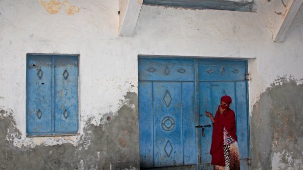 A Somali girl looking for her missing younger sister stands outside the mortuary of a hospital in Mogadishu.