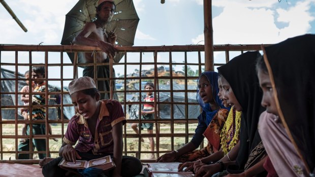 Rohingya children study the Koran at a makeshift mosque in a refugee camp outside Cox's Bazar, Bangladesh.