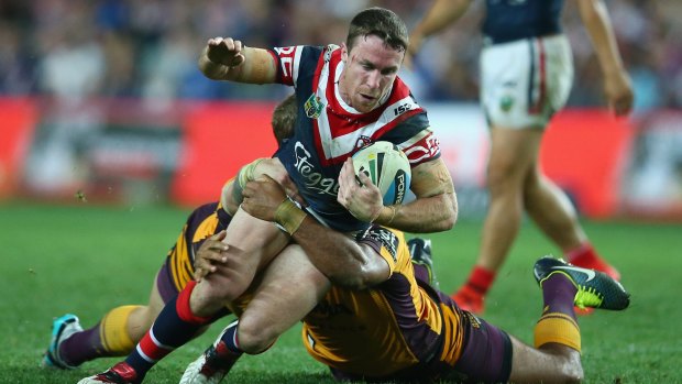 SYDNEY, AUSTRALIA - AUGUST 22:  James Maloney of the Roosters is tackled during the round 24 NRL match between the Sydney Roosters and the Brisbane Broncos at Allianz Stadium on August 22, 2015 in Sydney, Australia.  (Photo by Mark Kolbe/Getty Images)
