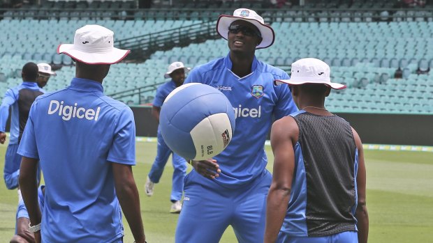 Testing times: West Indies captain Jason Holder warms up with a medicine ball at the SCG.