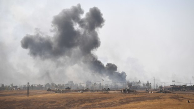 Smoke billows from a combined aircraft, artillery and ground attack to recapture the village of Tiskharab from Islamic State.