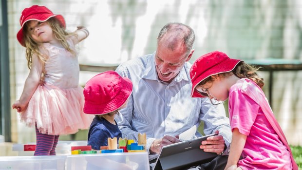 Professor Tom Lowrie of the University of Canberra's STEM Education Research Centre plays with children from the Wiradjuri Pre-school. 