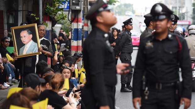 Police officers on duty dressed in black for King Bhumibol Adulyadej's death at the age of 88.