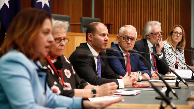 Energy Minister Josh Frydenberg and Prime Minister Malcolm Turnbull with energy regulators at Tuesday's press conference.