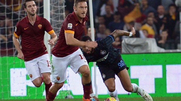 Roma's Francesco Totti vies with Inter's Yann Mvila.