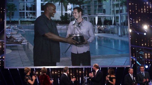 Andy Murray, right, receives the Sports Personality of the Year award from Lennox Lewis.