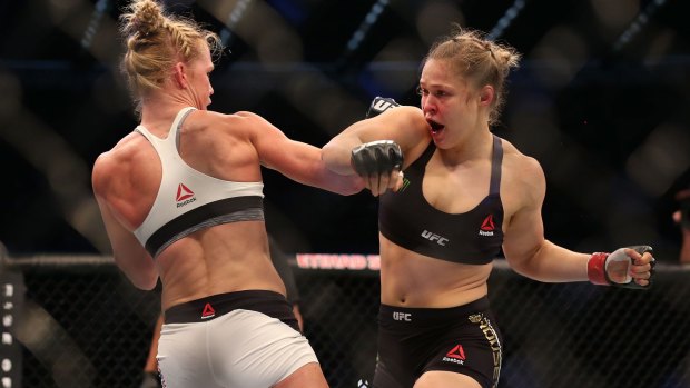 Failed defence: Favourite Ronda Rousey (right) had no answers for Holly Holm (left), losing her UFC world bantamweight title. 