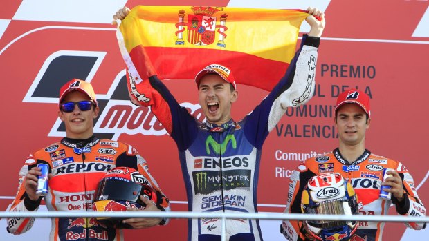 Jorge Lorenzo celebrates on the podium next to Marc Marquez, left, and Dani Pedrosa, right.