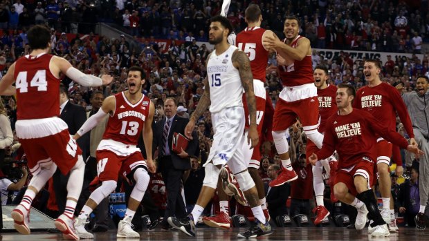 Kentucky's Willie Cauley-Stein walks off the court as the Wisconsin Badgers celebrate.