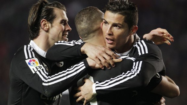 Real Madrid's Karim Benzema (centre) celebrates with teammates Gareth Bale (left) and Cristiano Ronaldo.